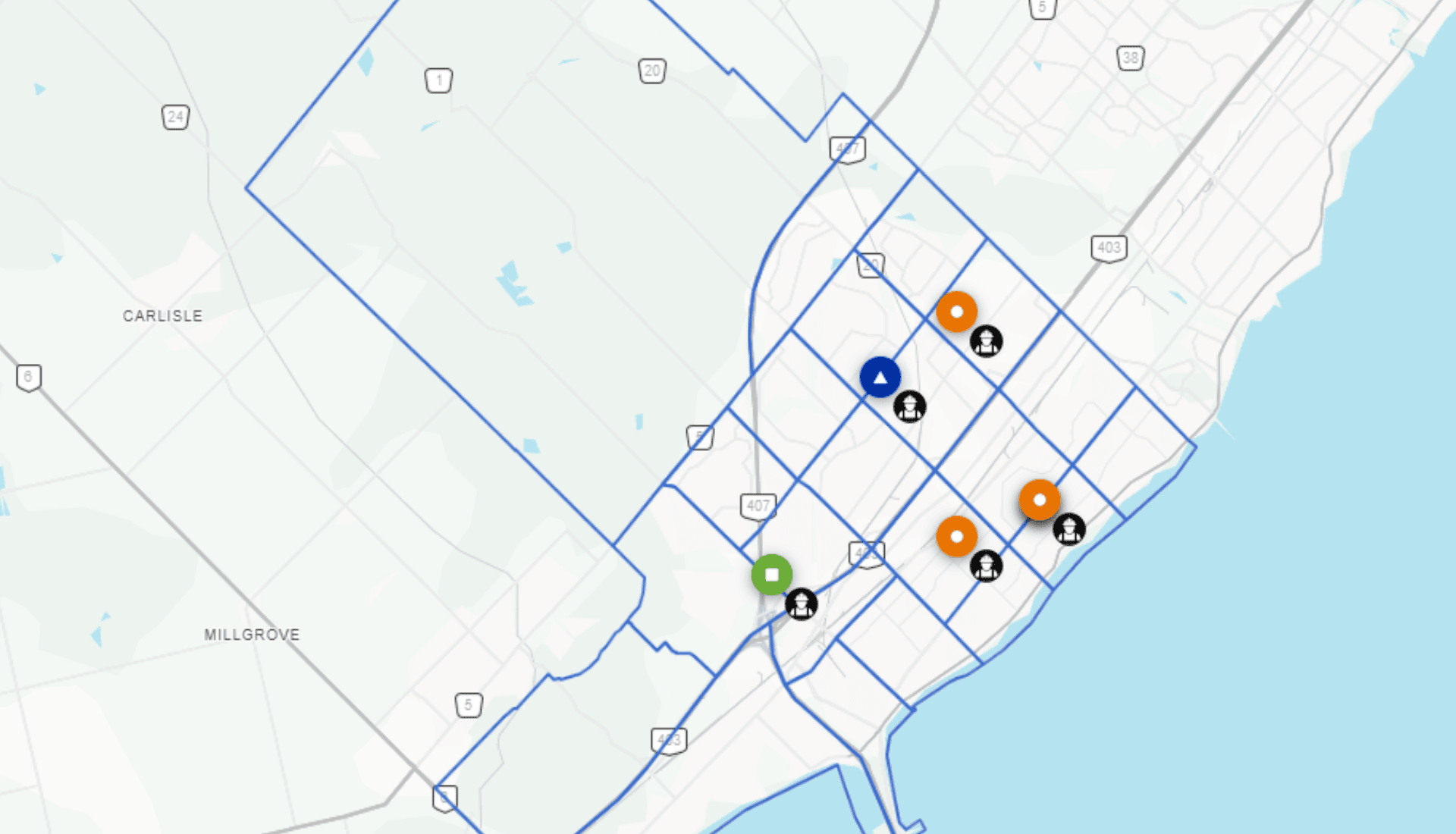 A map with blue boundary lines, coloured markers, and icons indicating different locations in a city area near a shoreline.