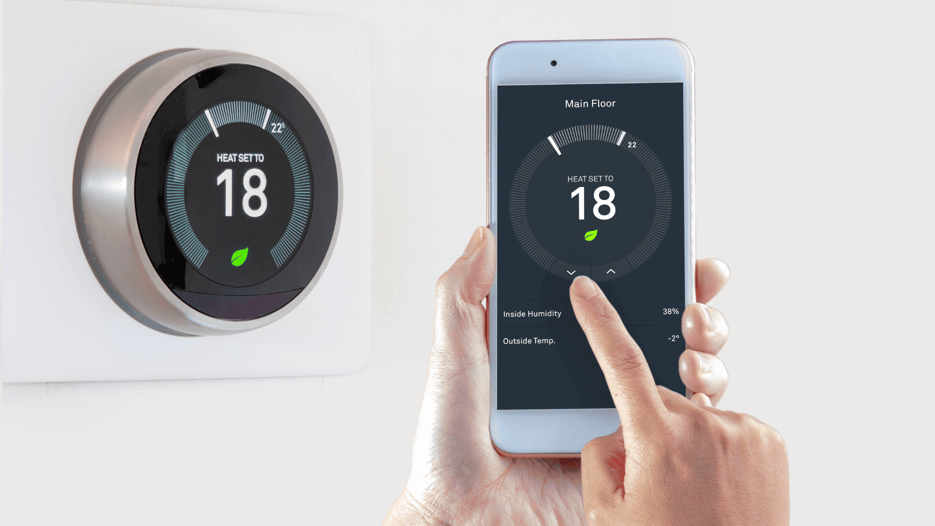 A hand adjusts a smart thermostat set to 18°C using a mobile app showing matching temperature settings.